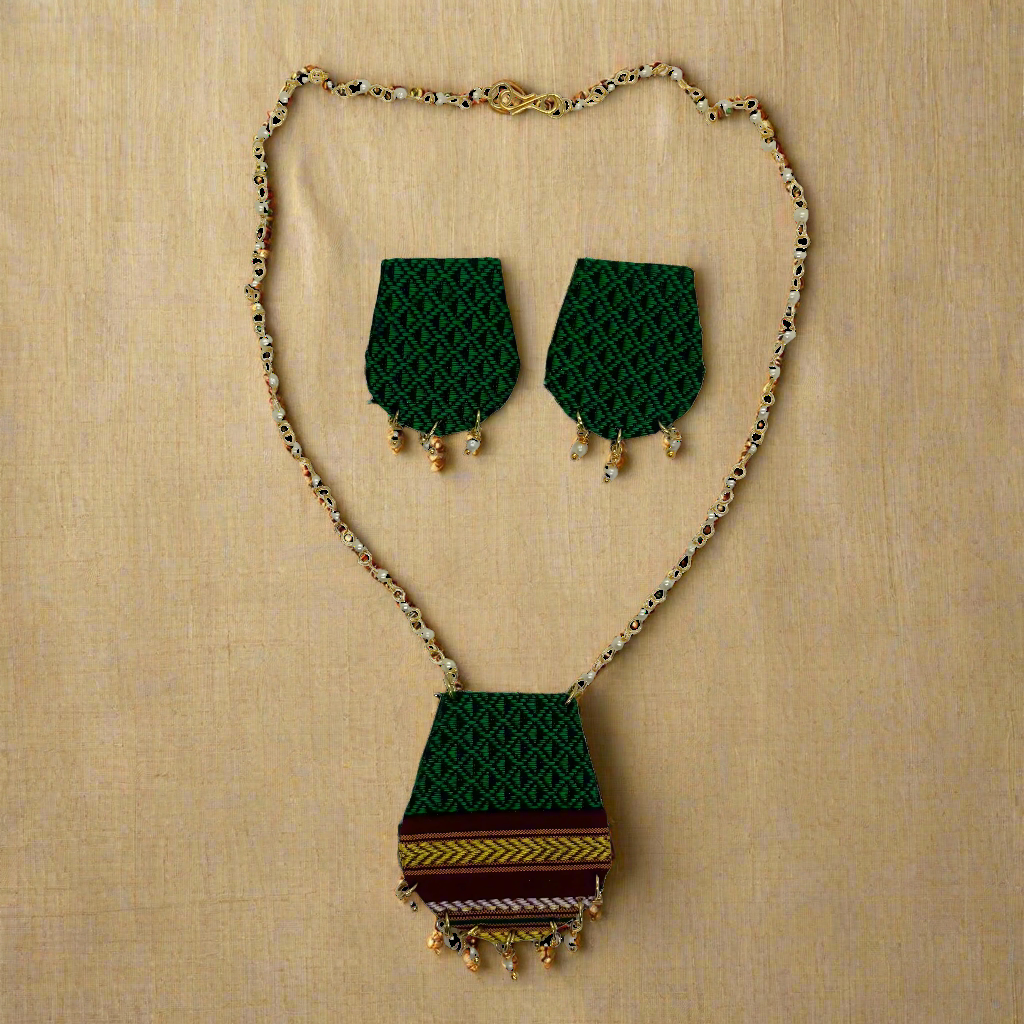 Jewelry set with green patterned necklace and earrings on a white background