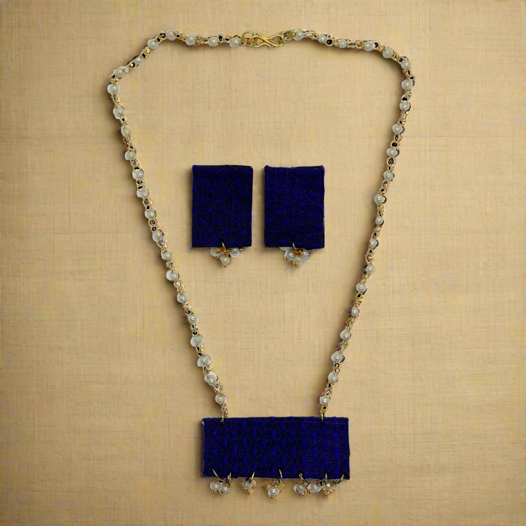 Navy blue necklace and earrings set on a white background