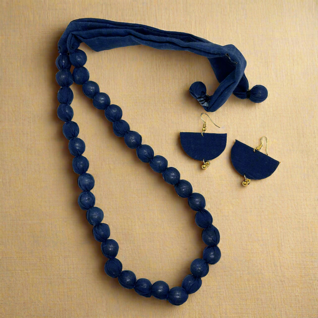 Navy blue beaded necklace and earrings set on a white background