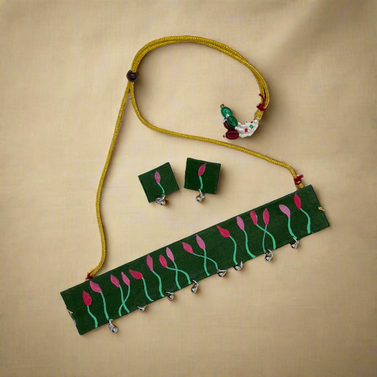 Jewelry set with green necklace and earrings on a white background