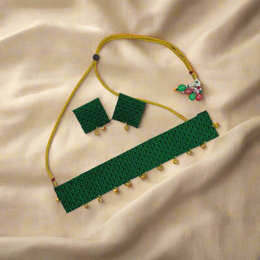 Green beaded necklace, bracelet, and earrings set on a white background