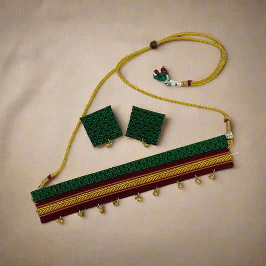 Decorative belt with green and gold patterns on a white background