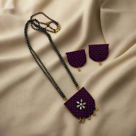Purple necklace with matching earrings on a white background