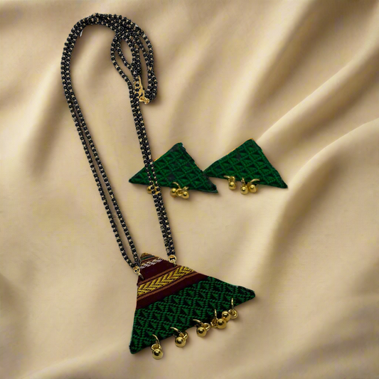 Necklace with green and gold pendant on a white background