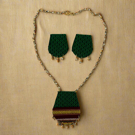 Jewelry set with green patterned necklace and earrings on a white background