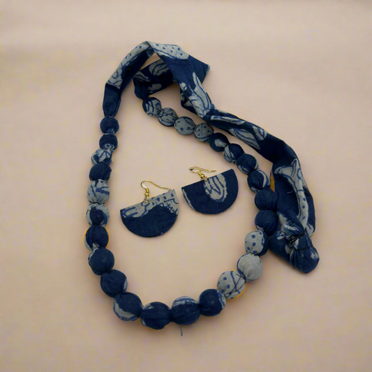 Navy blue and white marbled necklace with matching earrings on a white background